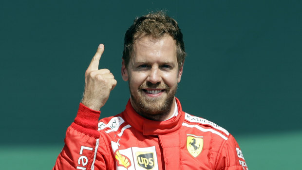 Ferrari driver Sebastian Vettel celebrates winning the British Formula One Grand Prix at the Silverstone on Sunday.