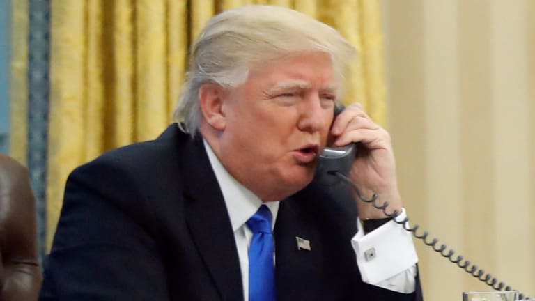 The phone guy: President Donald Trump speaks to then Australian prime minister Malcolm Turnbull on a landline in the Oval Office of the White House on January 28, 2017.