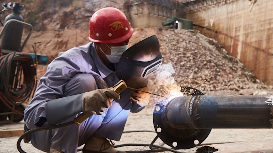 An employee of China Water & Electric Corp welds pipework at the construction site of the Gwayi-Shangani dam, 245km north-west of Bulawayo, Zimbabwe, in June.