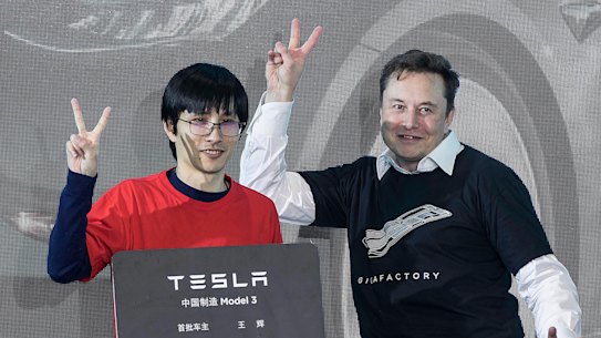 Tesla CEO Elon Musk with car owners at the its Shanghai factory. His leadership may be eccentric, but investors have decided to back the carmaker anyway.