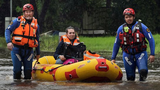 SES teams rescue Simone Baluch, her dog and a litter of kittens from a property in Chipping Norton on Thursday. 