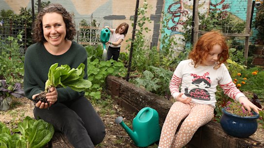 Paddock Community Garden coordinator Caroline Sleap, front, and Paddock Community Garden president Harriet Blundell working in the garden beds. June 18th, 2022. Photo: Dylan Coker/The Sydney Morning Herald
