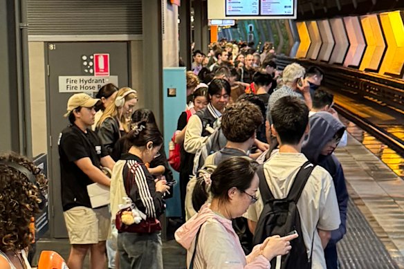 Commuters waiting at Chatswood station during the storm.