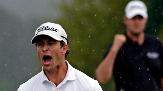 Marc Leishman celebrates Adam Scott’s birdie putt on the 72nd hole.