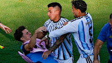 Spain’s Gavi falls as he scuffles with Argentina’s Leandro Paredes.