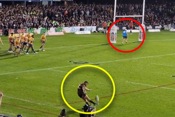A Parramatta trainer runs in front of the goalposts as Nathan Cleary attempts a conversion attempt during a match in 2022.