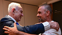 Yaniv Hayoun, right, greets Israeli Prime Minister Benjamin Netanyahu.