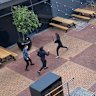 A photo taken by witnesses at Northland shows a person wielding a knife lunging at two other people.