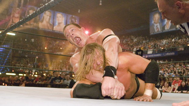 John Cena and Triple H grapple at Wrestlemania 22 in 2008. 