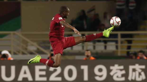 Flying high: Abdelaziz Hatem and Qatar condemned Iraq to a quarter-final exit for the first time since 1972.