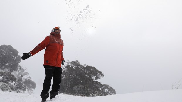 A winter warrior revels in the snow at Thredbo on Thursday as blizzards blanket the Snowy Mountains.