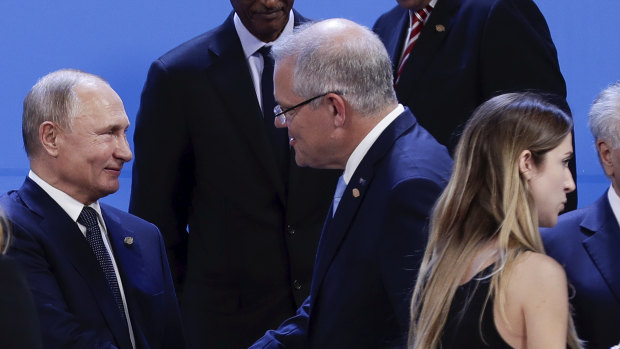 Russian President Vladimir Putin greets Prime Minister Scott Morrison during the family photo at the G20 summit.