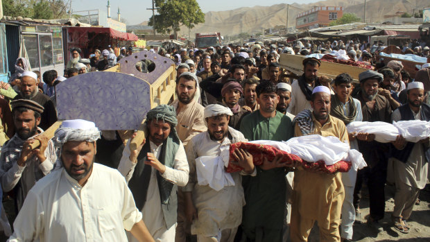 Baghlan province residents carry the bodies of children killed in an air strike in northern Afghanistan on Saturday.