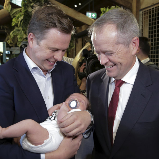 Opposition Leader Bill Shorten with his chief of staff Ryan Liddell, holding baby Ivy.
