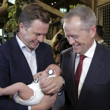 Opposition Leader Bill Shorten with his chief of staff Ryan Liddell, holding baby Ivy.