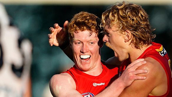 Matt Rowell and Hugh Greenwood celebrate a goal.