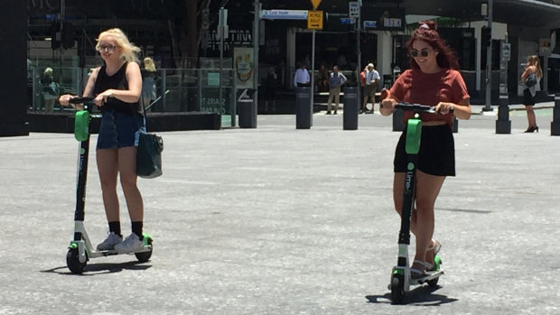 Lime scooter riders risk brain injury and death while zipping around without helmets on in Brisbane city.