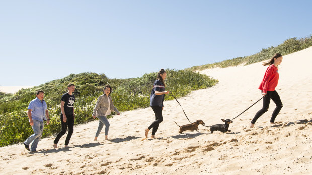 Greg and Nerida Coman with their children Tallis, Amelie and Lilia at the sand dunes near their Cronulla home.