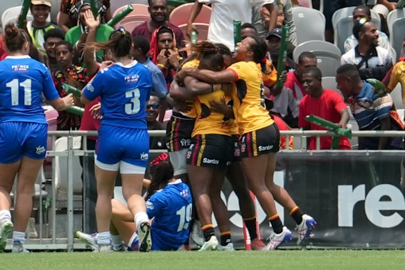 The PNG women’s team celebrates scoring a try against France in Port Moresby.