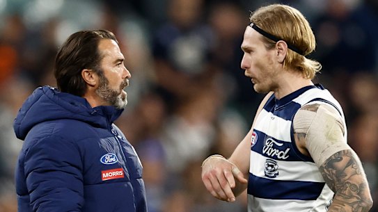 Chris Scott speaks with Cats star Tom Stewart in a break in play during Geelong’s clash with Carlton.
