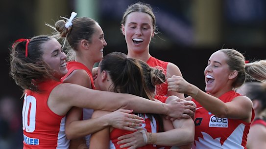 Sydney Swans players celebrate Laura Gardiner’s goal at the SCG against Essendon.