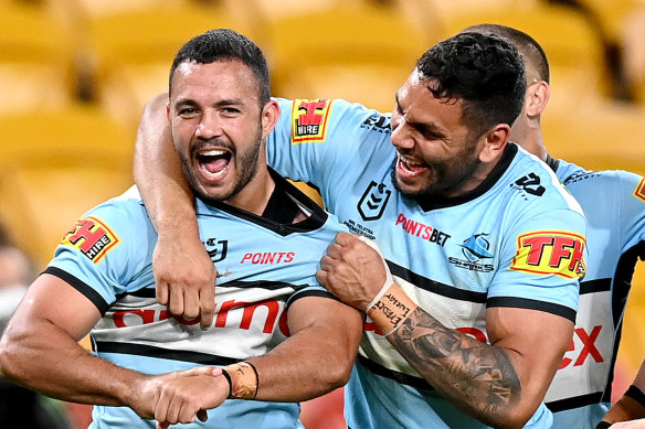 Braydon Trindall (left) celebrates his try for the Sharks against the Broncos.
