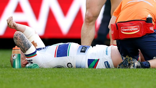Warriors skipper Mitchell Barnett receives treatment on his injured knee on Sunday. 