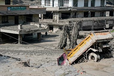 Damaged houses and vehicles are seen in the aftermath of flash floods along the Trishuli River.