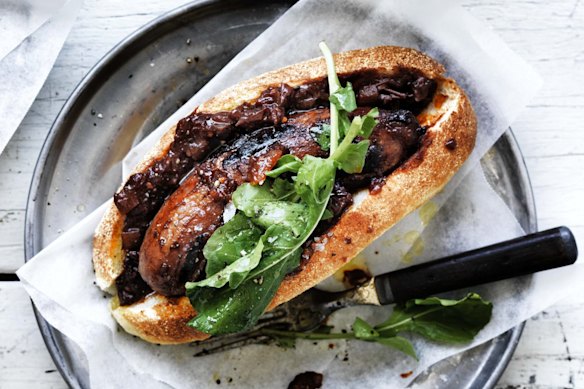 The secret is to cook the snag in sauce: Adam Liaw's perfect barbecued sausage in a bun.