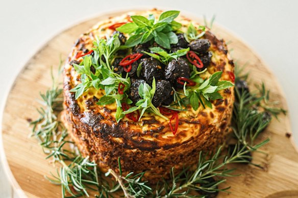 Baked spiced ricotta cake with a central layer of jammy tomatoes.