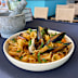Gigli is a small, fluted dried pasta rolled in the shape of a cone or flower with ruffled edges.