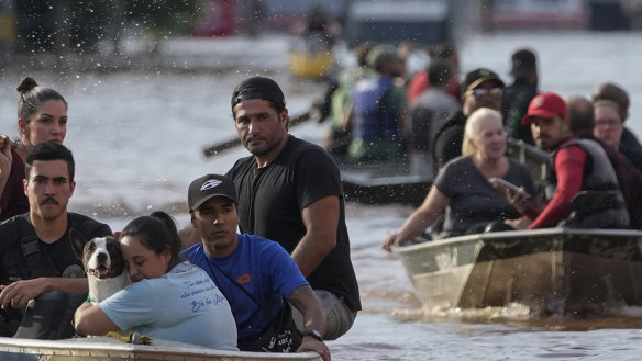 Volunteers help to evacuate residents from an area flooded by heavy rains, in Porto Alegre, Brazil, on Tuesday.