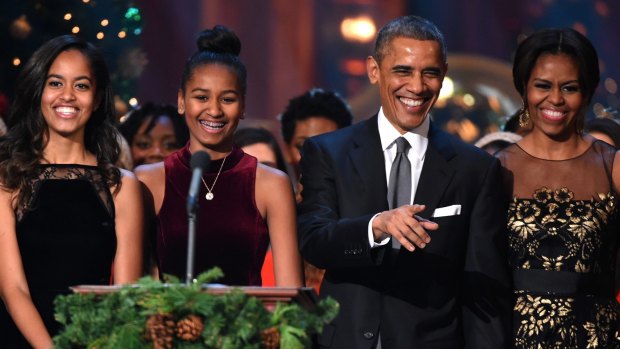 Barack and Michelle Obama with their daughters Malia and Sasha in 2014.