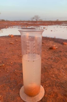Postmistress Janet Beetson checks the rain gauge in the south-western Queensland town of Thargomindah. 