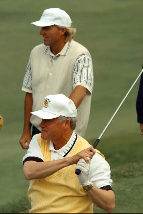 Bill Clinton and Greg Norman play golf together in Australia.