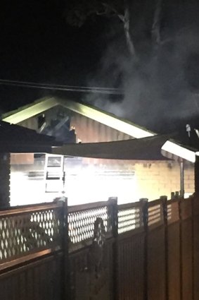 Smoke rises from a detached garage after a fire sparked by an unattended heater in Kambah.
