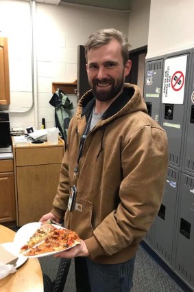 James Scott enjoys his pizza present in Portland, Maine.
