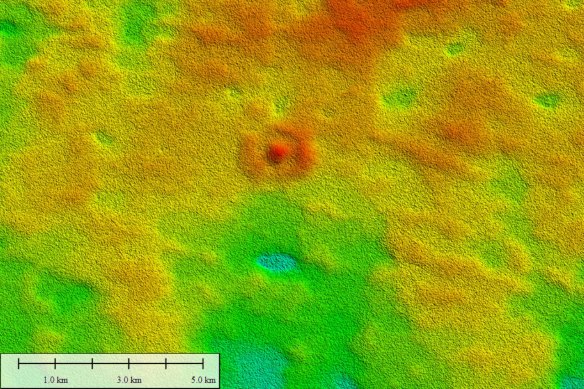 Reds indicate higher elevations and show an unusual bullseye structure rising to 10 metres above the surrounding plain, representing a remnant of a biological mound from about 14 million years ago.