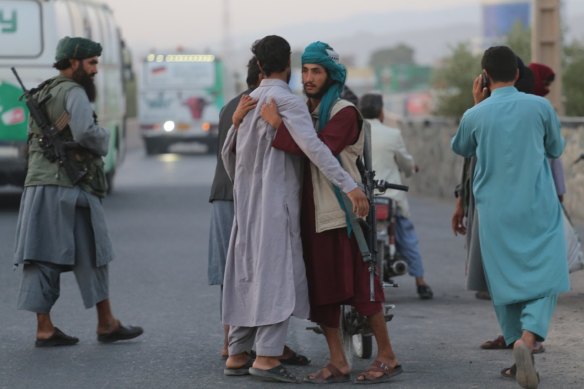 A Taliban soldier frisks someone at a checkpoint in Herat. 