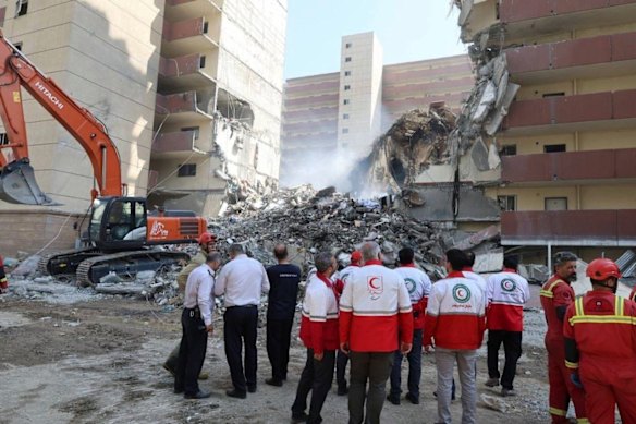 Iranian red society society work in scene of an explosion after an Israeli strike in Tehran.