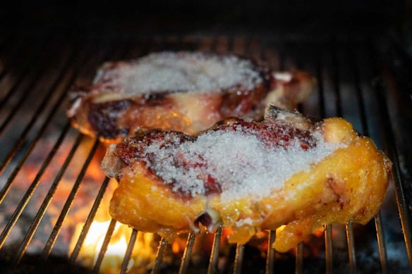 Basque txuleton steak being prepared over coals at Casa Julian.