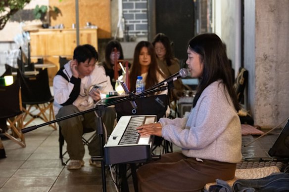 A singer performs outside a bar in Dali’s old town district. The city has long been a haven for musicians and creatives. 