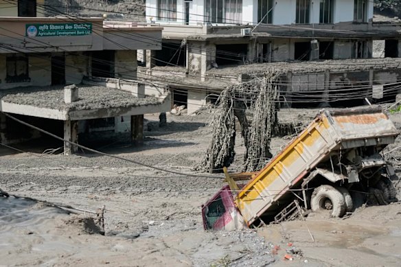 Damaged houses and vehicles are seen in the aftermath of flash floods along the Trishuli River in Nepal’s Nuwakot district.