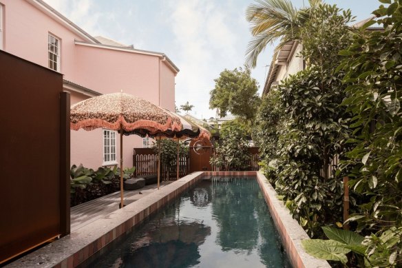 The lap pool at Miss Midgley’s in New Farm. The pattern on the pool umbrellas matches the 1860s wallpaper found behind plaster on an upstairs wall.