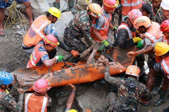 Kabir Maharjan, a mechanical supervisor, was pulled out of a hole in the ground amid cheering bystanders and put on a stretcher.
