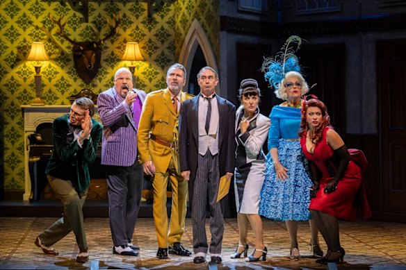 Some of the cast of Cluedo (left to right): Laurence Boxhall (Reverend Green), David James (Professor Plum), Adam Murphy (Colonel Mustard), Grant Piro (Wadsworth), Rachael Beck (Mrs White), Genevieve Lemon (Mrs Peacock) and Olivia Deeble (Miss Scarlett).
