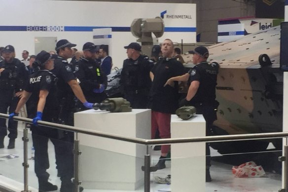 A protester reportedly climbed on top of a tank and locked themselves to it. 