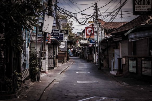 Poppies Lane in Kuta is completely deserted, with most businesses closed and no tourists in sight.  