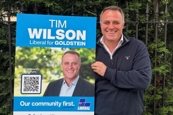 Tim Wilson proudly displays his election corflute. 