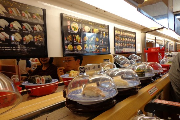 Inside a sushi conveyor belt restaurant in Japan.